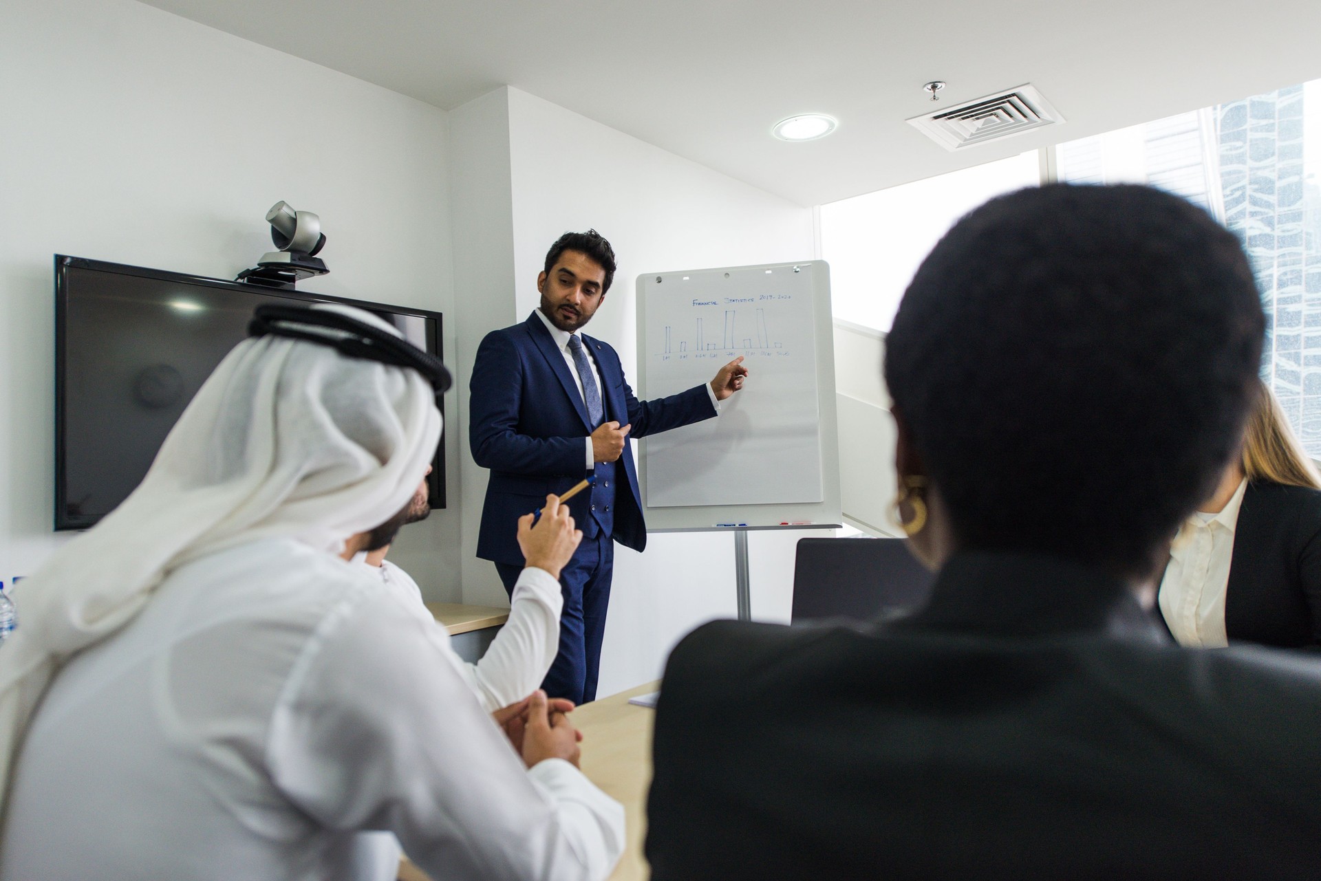 Businessman Giving Presentation To Colleagues In Office Meeting